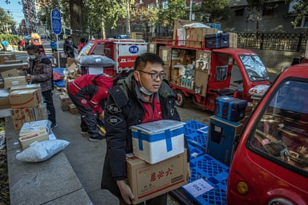 JD.com staff lift and carry parcels