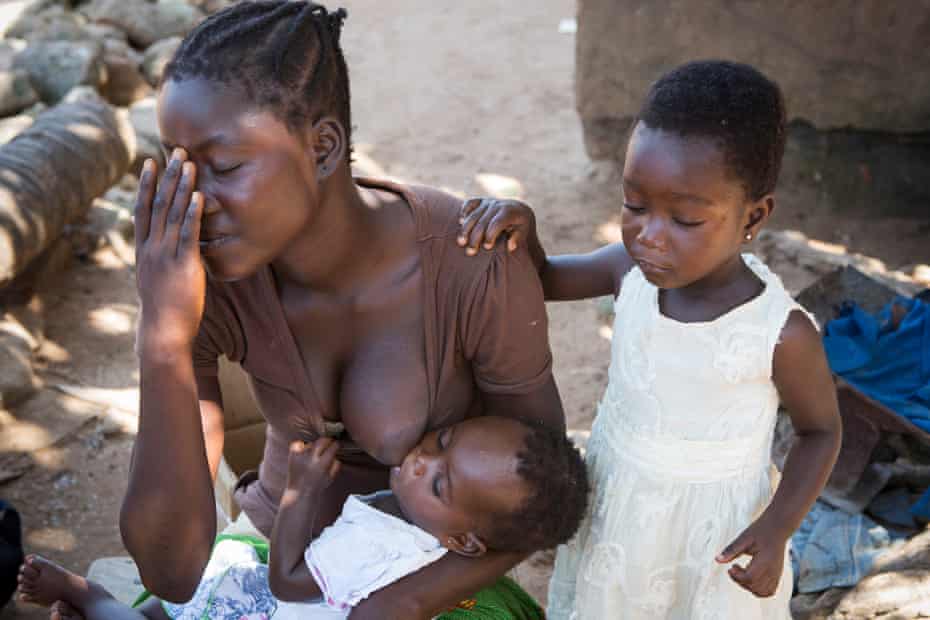 Rachel Edifile, 18, with her two children at her home in Nyanyano, where she works as a fishmonger. Her youngest child is underweight and malnourished, and she relies on help from her grandmother to pay for medical costs