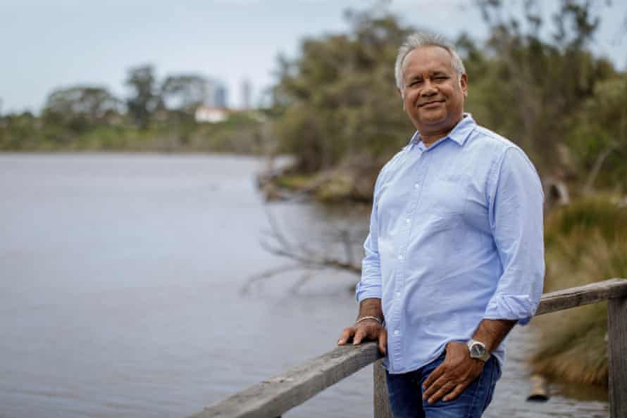 Noongar artist Barry McGuire stands on the banks of a river