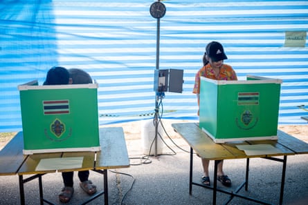 Voters prepare their ballots at a polling station during advance voting in Phuket