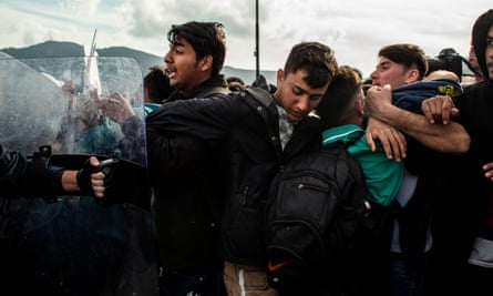 Scuffles have broken out between migrants and riot police on Lesbos amid a surge from Turkey after it opened its borders to thousands of refugees trying to reach Europe.