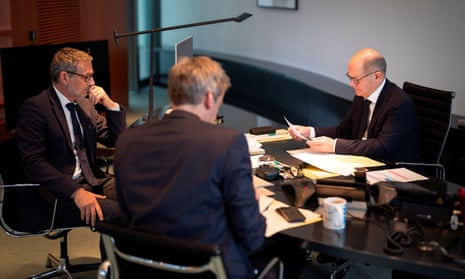 Olaf Scholz, right, during a phone conversation with Vladimir Putin as the German foreign and security policy adviser Jens Plötner and government spokesperson Steffen Hebestreit look on in Berlin.