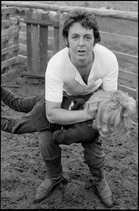 Paul plays with Heather in the mud, 1971.