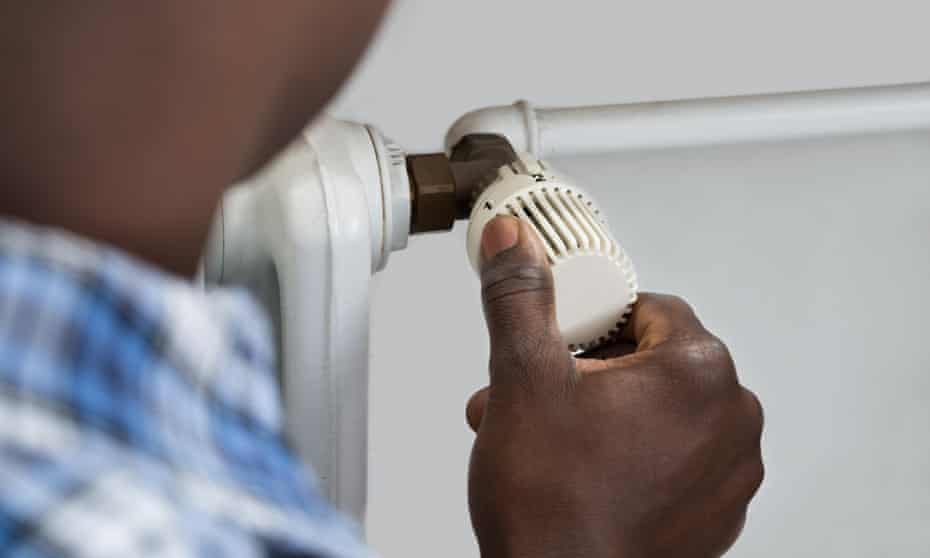 Close-up of a person adjusting thermostat valve