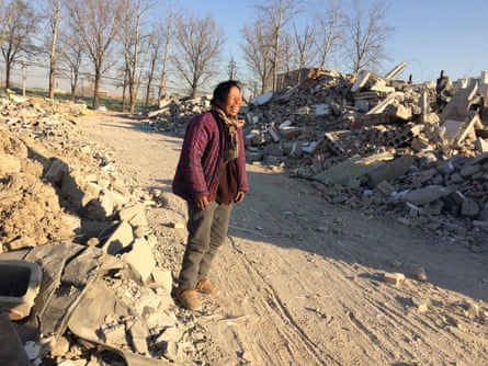 Zheng Yuzhi, a migrant from Shandong, has dug a shelter in the ground after losing her home.