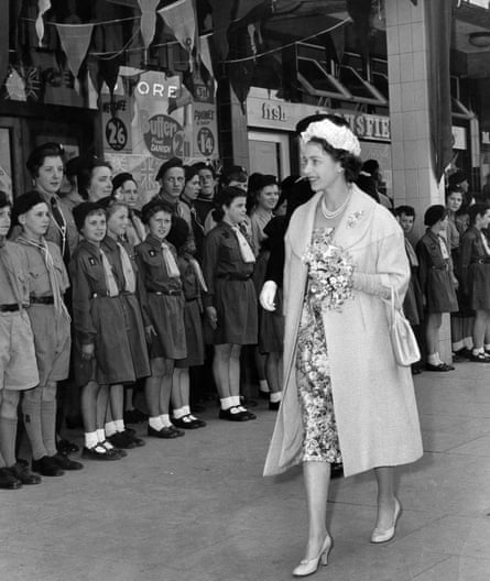 Queen Elizabeth II walks past a line of people