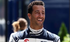Daniel Ricciardo of AlphaTauri smiles in the paddock at the Hungaroring
