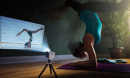 A lady practices yoga using the mobile projector