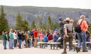 Visitors watch Old Faithful erupt on Monday afternoon on Yellowstone national park’s opening day.