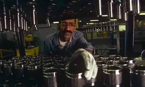 A man sorting car parts in a factory