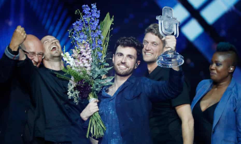 Duncan Laurence, representing the Netherlands, lifts the glass microphone trophy after being announced the winner. 
