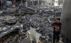  A Palestinian child walks among the rubble of buildings destroyed by Israeli attacks.