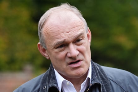 Ed Davey in a wax jacket talking outdoors.