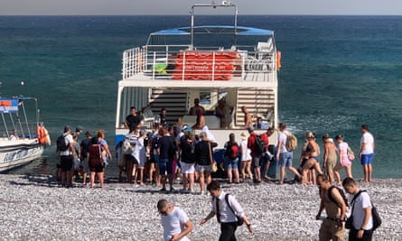 Tourists being evacuated near Lindos.