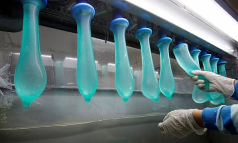 A worker performs a test on condoms at Malaysia’s Karex factory.