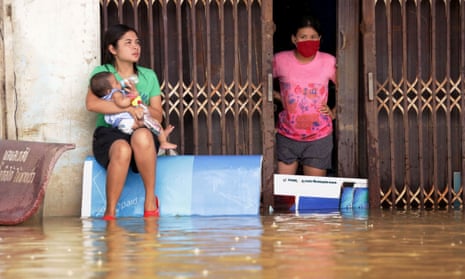 Women look out from a flooded house in the southern Thai village of Chauat on January 7, 2017. Heavy rains continued to hammer Thailand’s flood-ravaged south on January 7, bringing the death toll up to 12 and leaving thousands of villages partially submerged, authorities said. / AFP PHOTO / TUWAEDANIYA MERINGINGTUWAEDANIYA MERINGING/AFP/Getty Images
