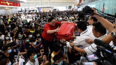 'You're not sorry': Hong Kong protesters block travellers from entering departure gates – video