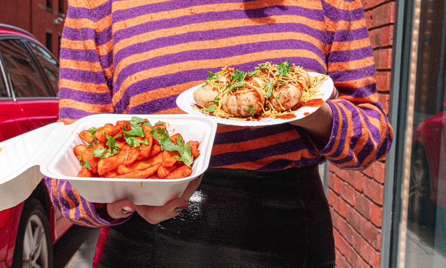 A waitress carrying two dishes at Lily’s Deli, Ancoats