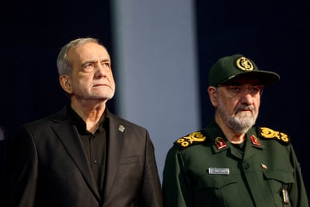 Masoud Pezeshkian, in civilian dress, and Mohsen Rezaei, in uniform, stand side by side