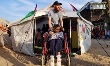 A Palestinian child receives respite care at a tent in Rafah