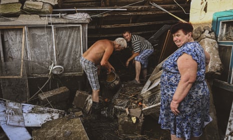 A family from the village of Vasylivka, in the Mykolaiv region, confront the damage to their home caused by the flooding.