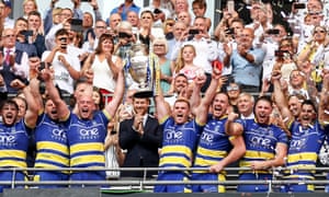 Prince Harry and Tony Adams look on as Warrington Wolves lift the Challenge Cup in 2019.