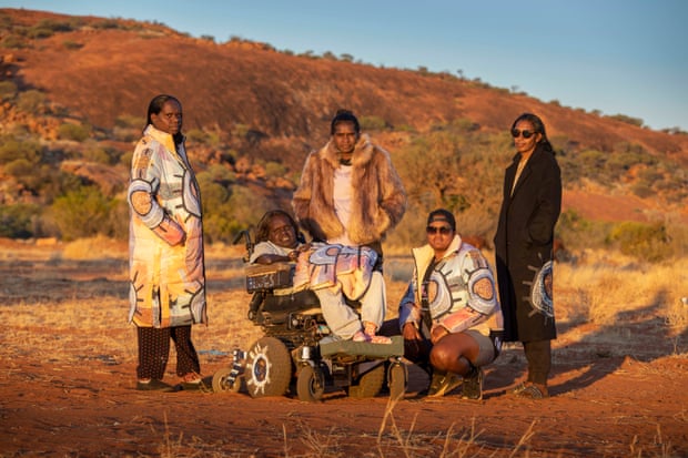Linda Puna (second from left) and family members in Mimili Community, wearing Linda Puna's collaboration with Unreal Fur.