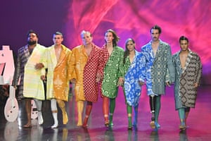 Models in colourful outfits and pink background