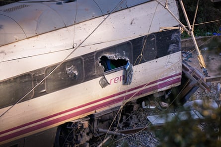 Closeup of a Renfe train carriage with smashed windows
