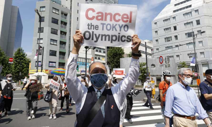 Anti-Olympics activists hold placards during a rally against the stay of the IOC President Thomas Bach in Tokyo.