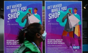 A pedestrian walks past a poster announcing vaccinations at the store in Primark on Oxford Street, London.  (Photo by Holly Adams/Getty Images)