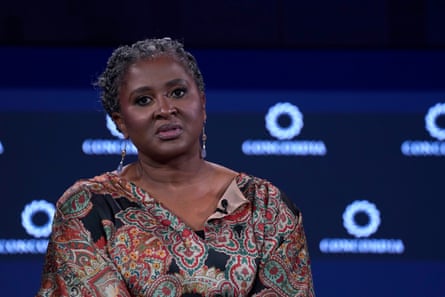 A middle-aged African woman speaking from a stage