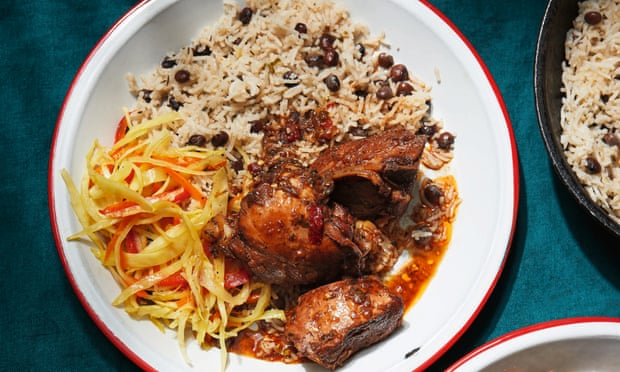 Brown stew chicken with rice and peas.