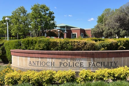 A stone sign is etched with the words 'Antioch Police Facility' and is surrounded by shrubbery.