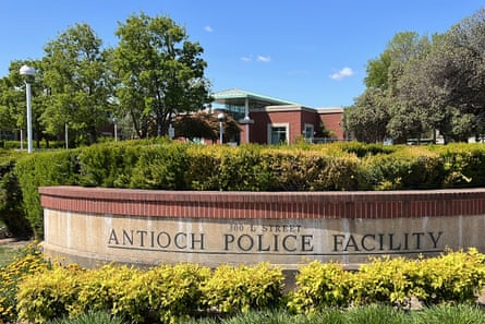 A stone sign is etched with the words 'Antioch Police Facility' and is surrounded by shrubbery.
