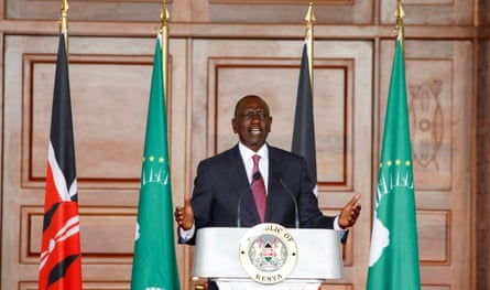 William Ruto surrounded by flags