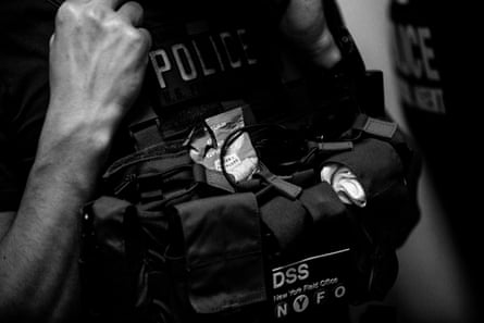 A half-eaten snack bar sticks out of a tactical vest