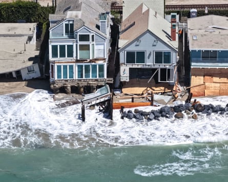 Waves wash up near damaged beachfront homes in Dana Point, California.