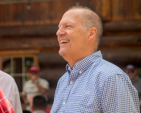 Man in check shirt at political event
