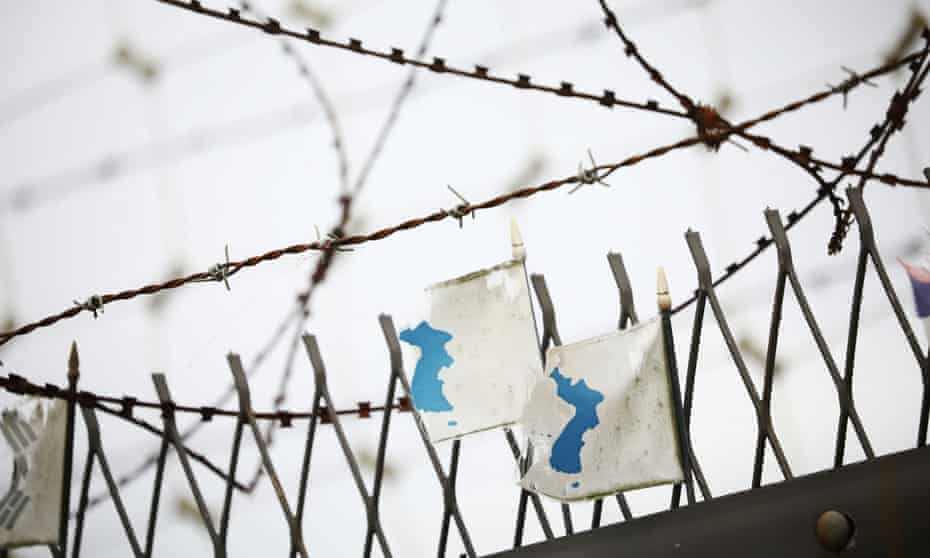 Korean unification flags on a military fence near the demilitarised zone separating North and South Korea. A rare defector from the South crossed the zone into the North on Saturday.