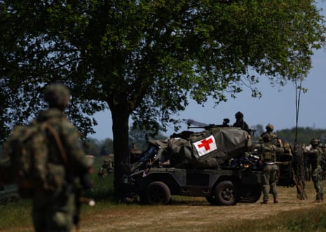 Soldiers stand near a vehicle as the Dutch military holds drills in De Wijk, the Netherlands.