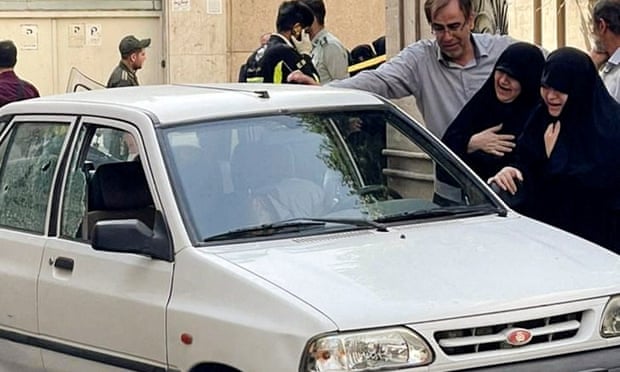 Family members of Colonel Sayad Khodai, a member of Iran's Islamic Revolution Guards Corps, weep over his body in his car after he was reportedly shot by two assailants in Tehran, Iran, May 22.