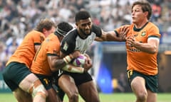 Australia’s Michael Hooper, right, moves in to tackle Fiji's Ponipate Loganimasi in their match at the Rugby Sevens Hong Kong tournament.