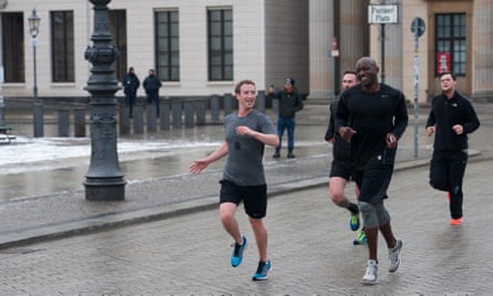 Facebook founder Mark Zuckerberg runs through Berlin with his personal bodyguards.