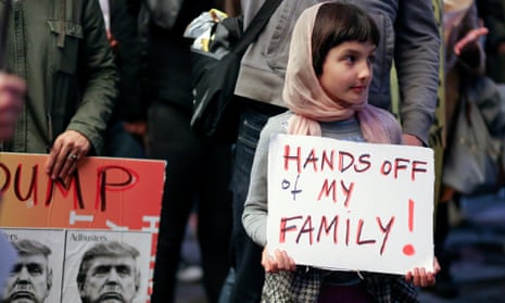 A young girl with protesters in LA to denounce the US travel ban from Muslim-majority countries.