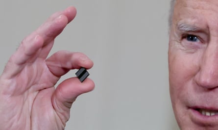 President Biden holds a semiconductor chip prior to signing an executive order aimed at addressing a global semiconductor chip shortage in February.