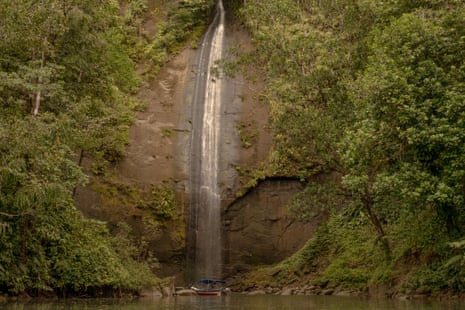 A waterfall tumbling into a pool between trees