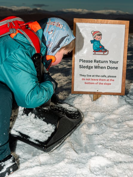 Sign in snow says Pleaase Return Your Sledge When Done