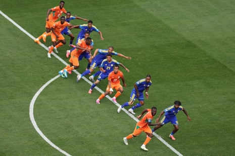 Players of Curacao and Cote d'Ivoire tussle for positions as a free-kick comes in.
