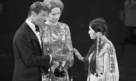 Sacheen Littlefeather, right, refusing to take the award for best actor from Roger Moore and Liv Ullmann, 1973.